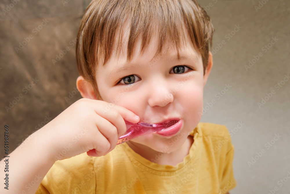 Close up portrait of a cute little baby brushing his teeth with a toothbrush. Kid aged two years (two-year-old boy) Close up portrait of a cute little baby brushing his teeth with a toothbrush. Kid aged two years (two-year-old boy)