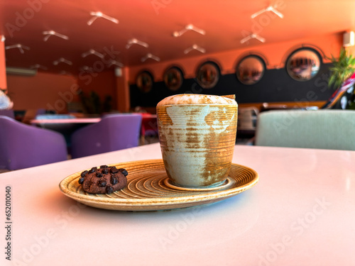 Cup of coffee and cookie in a nice modern cafe