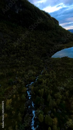 Flying over a lake reflecting a colourful sunset