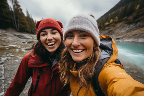 Two female friends taking selfies by a river during a hike along the mountain.generative ai