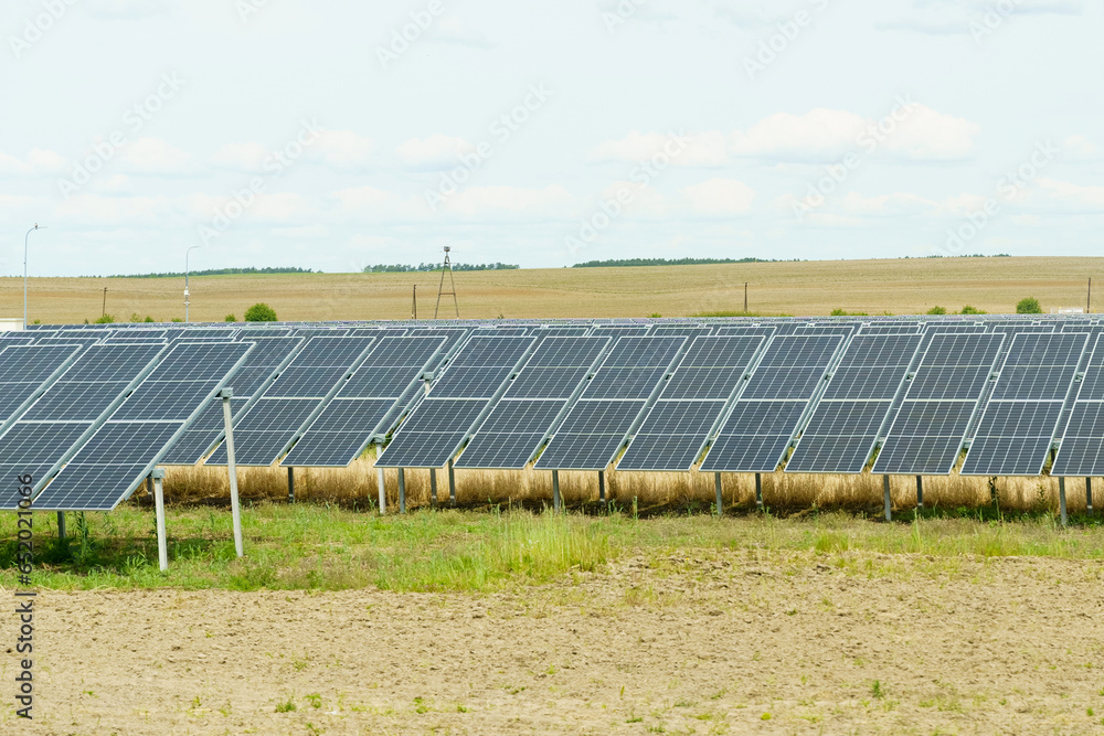 Solar panels on the field in summer, side view Solar panels on the field in summer, side view