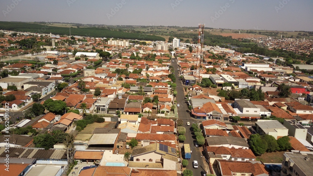 Urban landscape in aerial view of a small town, with the church and the square on a sunny morning on an ordinary day, taking in everything up to the horizon - Guapiacu - Sao Paulo - Brazil