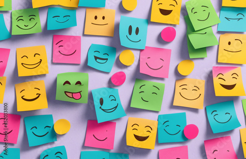 smiley face expression drawing on yellow colorful sticky notes adhesive post