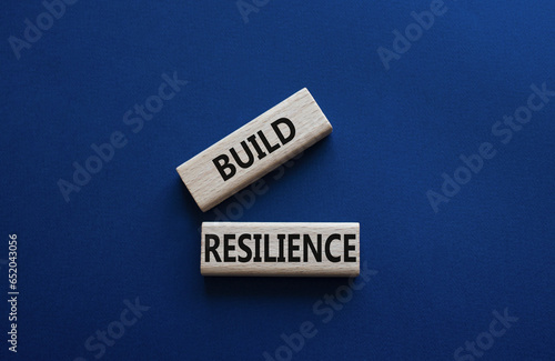 Build resilience symbol. Wooden blocks with words Build resilience. Beautiful deep blue background. Business and Build resilience concept. Copy space.