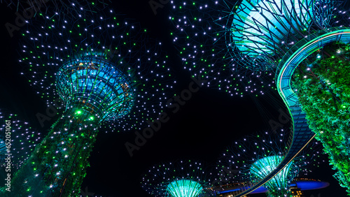 Gardens by the bay supertrees during garden rhapsody light show at night. Famous tourist attraction in Singapore.  photo