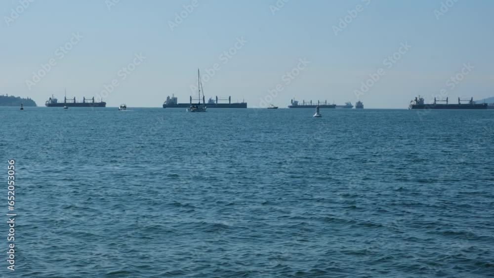 Ocean view with a sailing yacht and ships at a distance Ocean view with a sailing yacht and ships at a distance