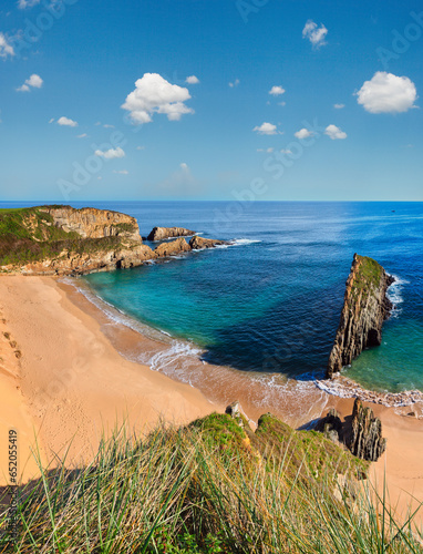 Sandy Mexota beach and pointed rock near (Spain). Atlantic Ocean coastline landscape. Two shots stitch image. photo
