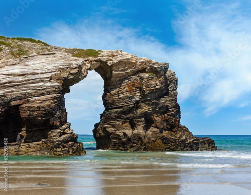 Natural rock arch on Cathedrals beach in low tide (Cantabric coast, Lugo (Galicia), Spain).