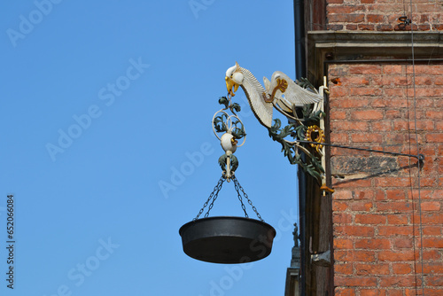 Smolna lantern on the building of the town hall of Gdansk. An eagle-shaped holder and a round bowl hunging from the eagle's beak. Gdansk, Poland photo