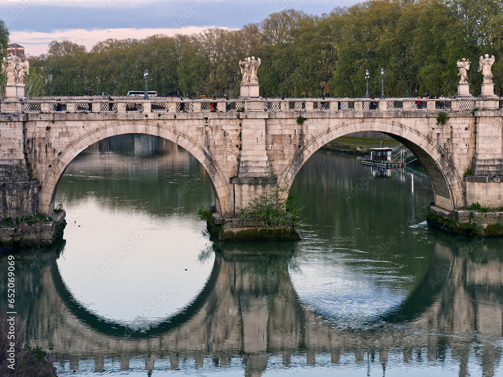Sant Angelo bridge reflecting in Tiber, Rome, Italy