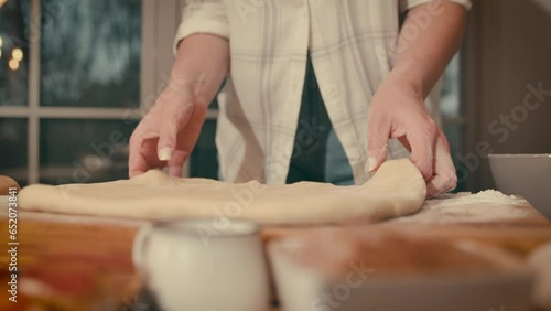 Close-up of a woman's hands, kneading dough and making bread according to recipe, isolated in her home kitchen 4k footage. High quality 4k footage.