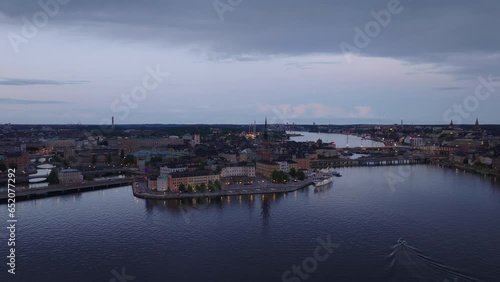 Aerial slide and pan shot of Riddarholmen Island and Kvarteret Luna with historic sights at dusk. Stockholm, Sweden photo