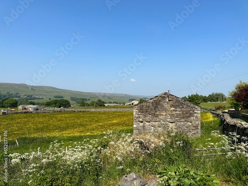 Rural landscape, next to to Marridales Road, with fields, stone barns, wild flowers, and distant hills in, Gayle, UK photo