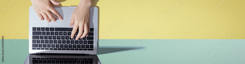 Person using a laptop computer from above Person using a laptop computer from above