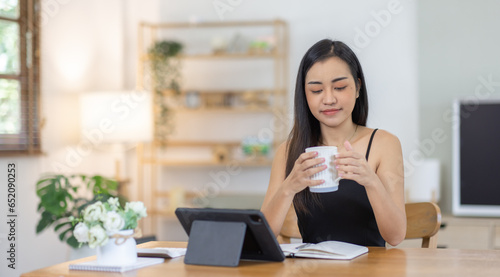 Portrait of smiling beautiful business asian freelancer woman working in office desk use computer copy space. Business people employee freelance online marketing e-commerce telemarketing concept