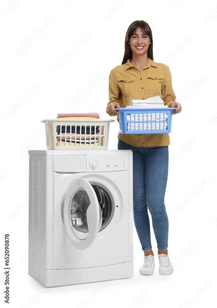 Beautiful woman with laundry basket near washing machine on white background Beautiful woman with laundry basket near washing machine on white background