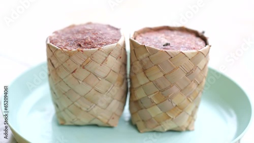 Terasi or shrimp paste in ecopacking. Indonesian seasoning made from fermented shrimp or fish in ecopackaging from bag weaving from mangrove palm leaves. photo