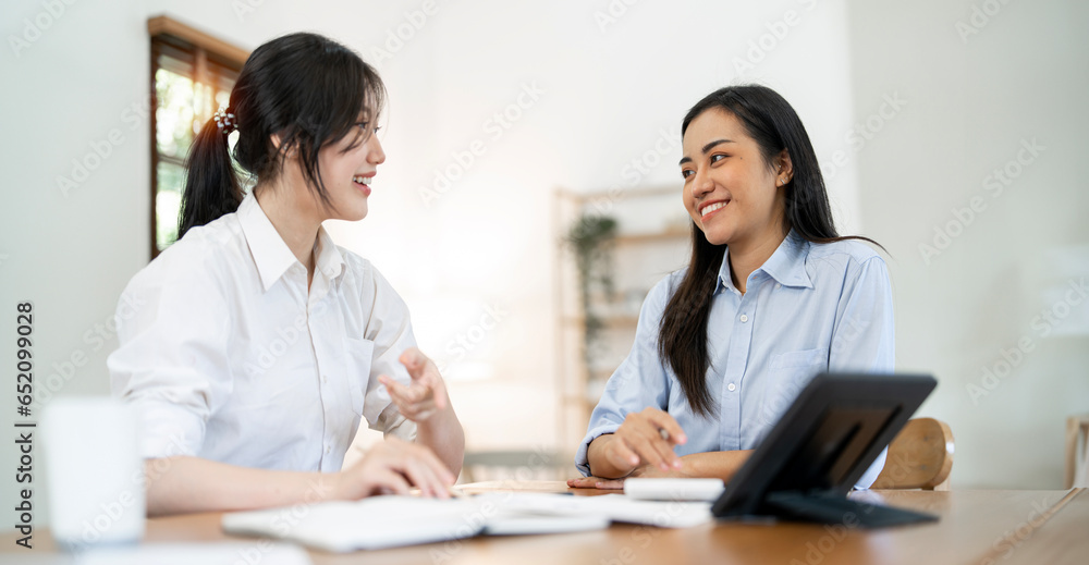 Happy business colleagues having casual discussion over tablet pc at home office. Happy business colleagues having casual discussion over tablet pc at home office.