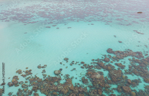 Aerial view of clear blue turquoise seawater, Andaman sea in Phuket island in summer season, Thailand. Water in ocean pattern texture wallpaper background.