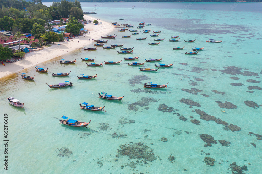Aerial top view of tourist boats in beach shore, river, pond or lake in summer season. Nature landscape background, Thailand.