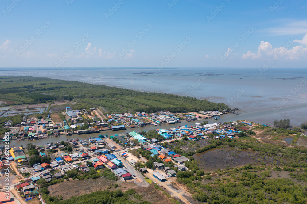 Aerial view of fishing trap net in canel with fisherman urban city village town houses, lake or river. Nature landscape fisheries and fishing tools at Pak Pha, Songkhla, Thailand. Aquaculture farming