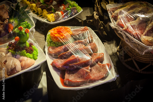 Decoration and raw foods that are wrapped with plastic wrap prepared for the wedding dinner party.