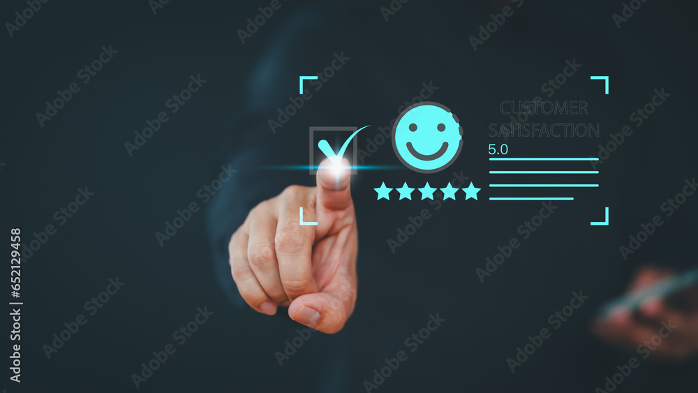 © ParinPIX - User hand touch virtual screen on smile face icon to give satisfaction in opinion on online application. Customer satisfaction survey, service experience rating, testimonial, feedback and review.