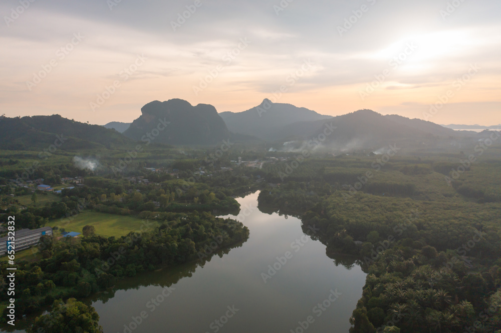 Obraz premium Aerial top view of a garden park with green mangrove forest trees, river, pond or lake. Nature landscape background, Thailand.