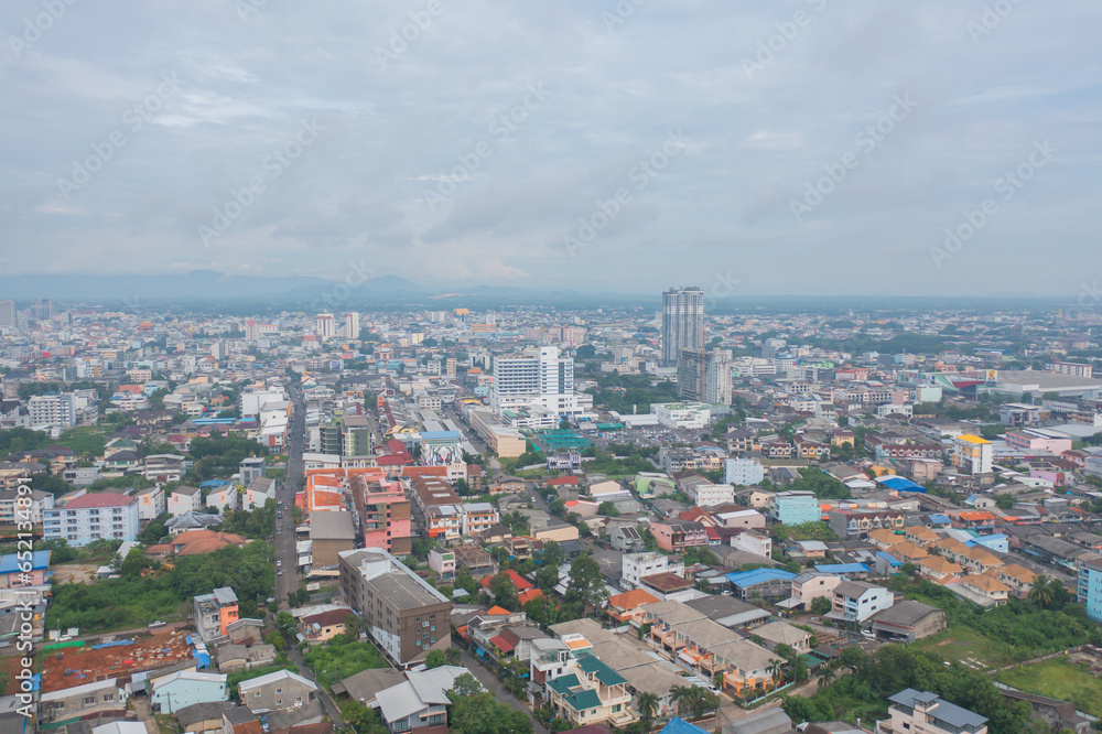 Fototapeta premium Aerial view of residential neighborhood roofs. Urban housing development from above. Top view. Real estate in Phuket, southern province city, Thailand. Property real estate.