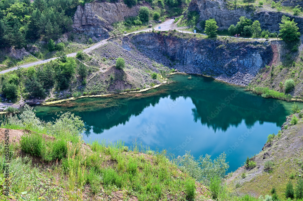 The Emerald Lake or Lacul de Smarald - wonderfully turquoise lake in a beautiful landscape near Racos, Brasov, Transylvania, Romania
