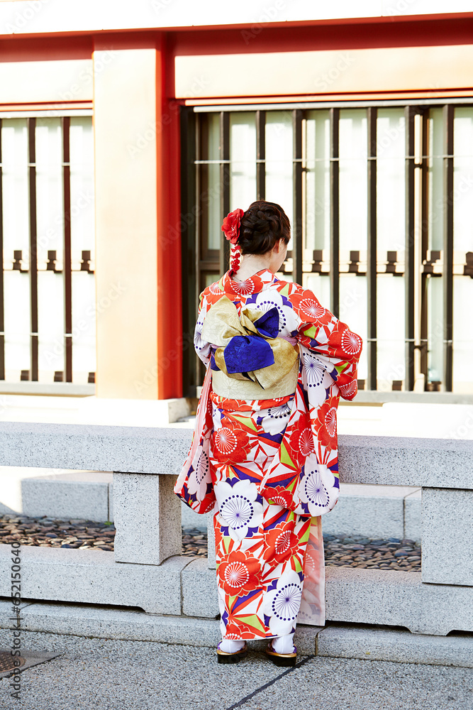 Back view of woman wearing kimono at temple