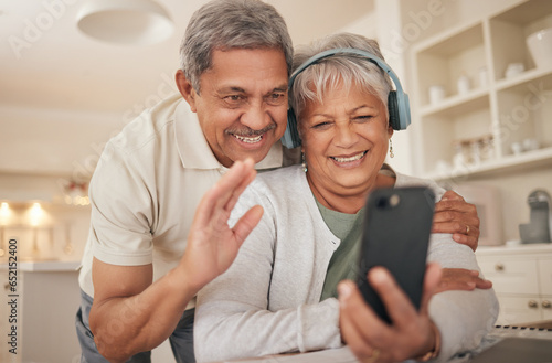 Home, video call and senior couple with love, smartphone and connection with internet, network and hello. Headphones, old man and elderly woman with a cellphone, online conversation and communication