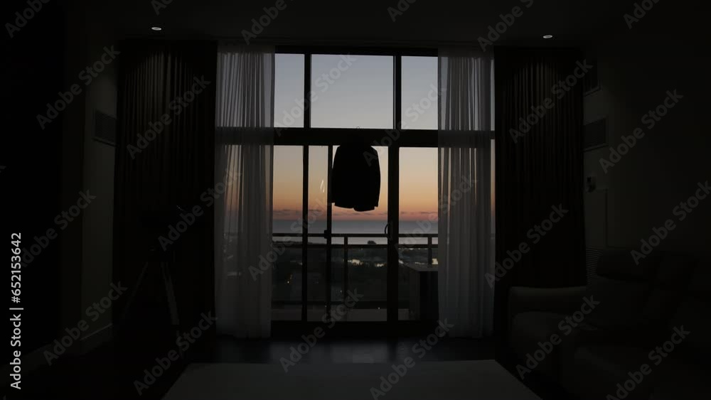 Preparation for the wedding, Groom's jacket hanging on the window in room Preparation for the wedding, Groom's jacket hanging on the window in room