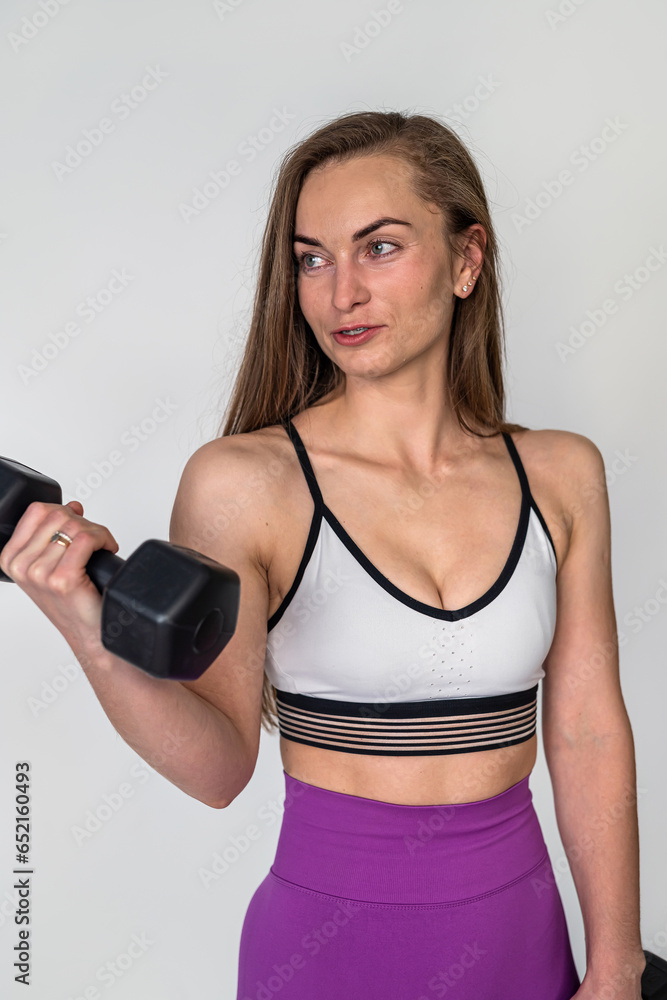beautiful fitness woman with dumbbells in hands posing on white isolated white background. beautiful fitness woman with dumbbells in hands posing on white isolated white background.