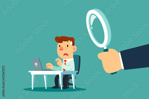 businessman at his work desk with big magnifying glass behind him