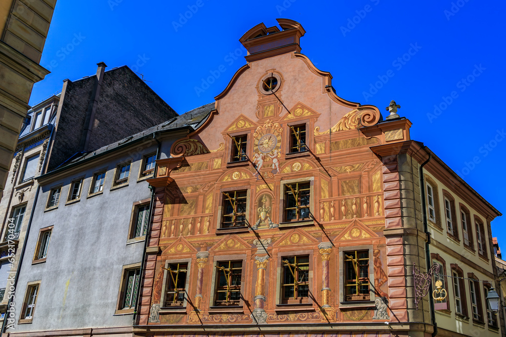 Ornate building with frescoes on the facade in the old town on Grande Ile, the historic center of Strasbourg, Alsace, France