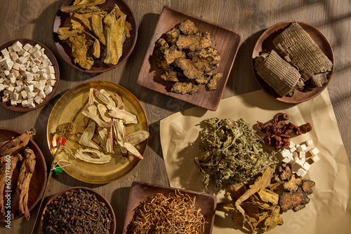 Fotografie Concept of healthy life with many types of traditional Chinese medicine arranged on many wooden plates and on a paper