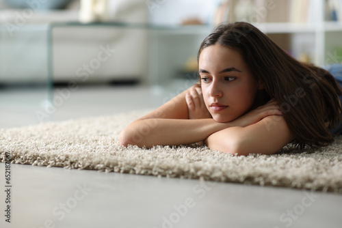 Sad woman on the floor at home