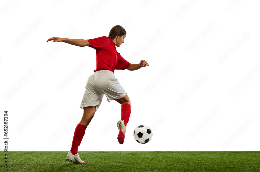 Winning game. Young athletic girl, football player in motion during game, playing isolated over white background
