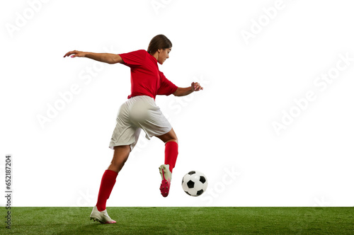 Winning game. Young athletic girl, football player in motion during game, playing isolated over white background © Lustre
