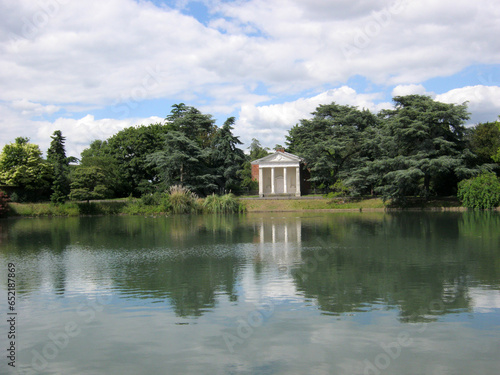 English landscape with a lake and a white gazebo on the shore