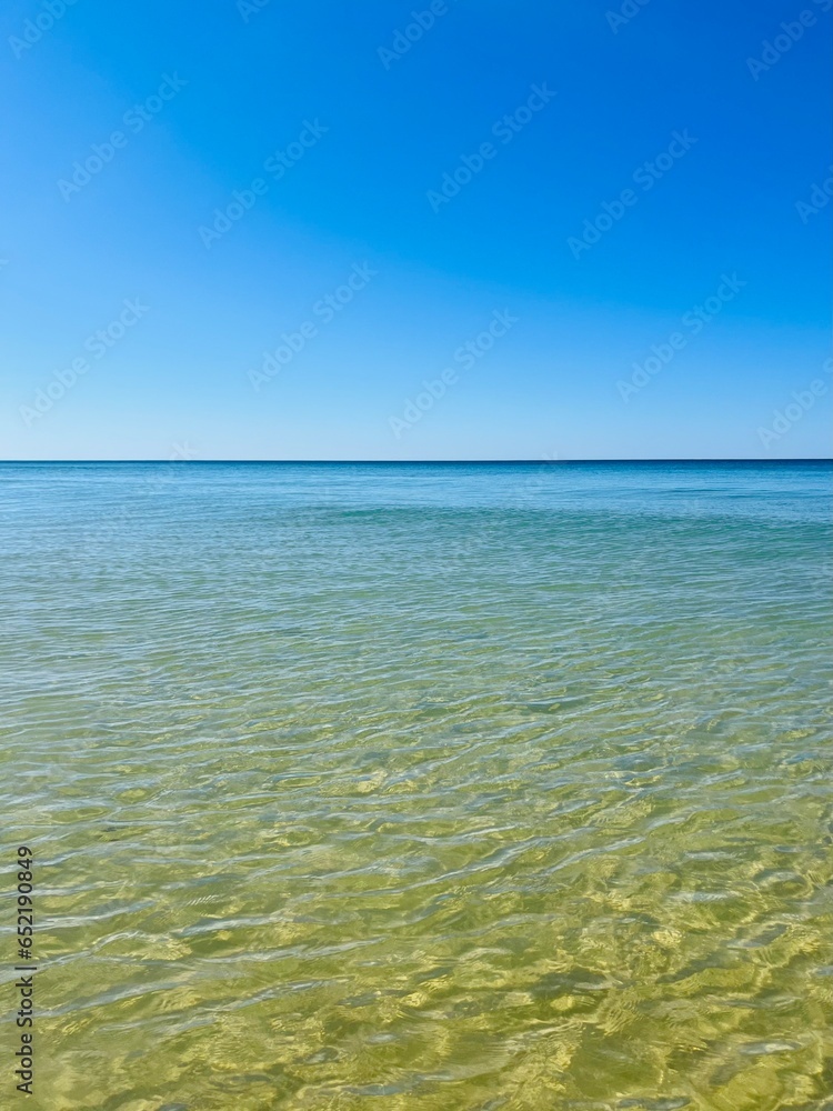 Calm transparent sea surface, blue sea horizon