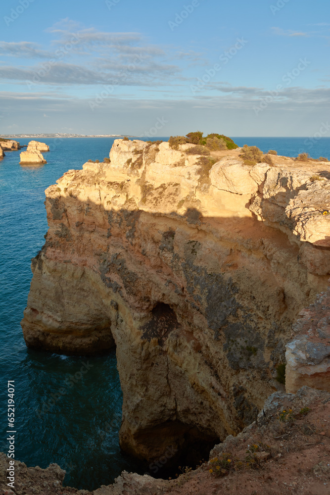 Natural limestone arch near the beach Praia da Marinha. Algarve, Portugal