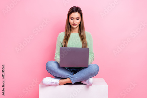Full size body cadre of focused young girl workaholic job every much tasks sitting podium seo analytic isolated on pink color background
