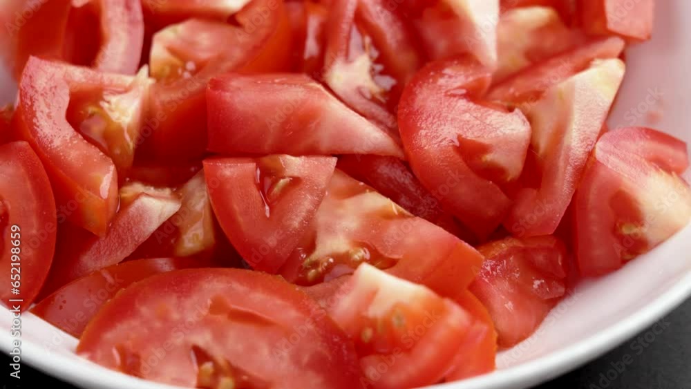 Chopped diced red ripe tomatoes in white ceramic bowl. Vegetable dietary ingredient close up. Rotation Chopped diced red ripe tomatoes in white ceramic bowl. Vegetable dietary ingredient close up. Rotation