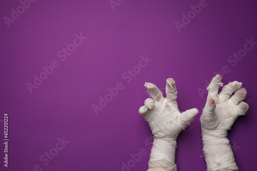 The mummy's hands are wrapped in a bandage