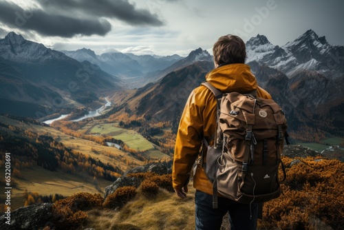 Rear view man hiking at sunset mountains with heavy backpack Travel Lifestyle wanderlust adventure concept summer vacations outdoor alone into the wild