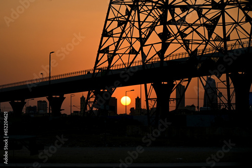Silhouette of a bridge at sunset in Riyadh, Saudi Arabia.