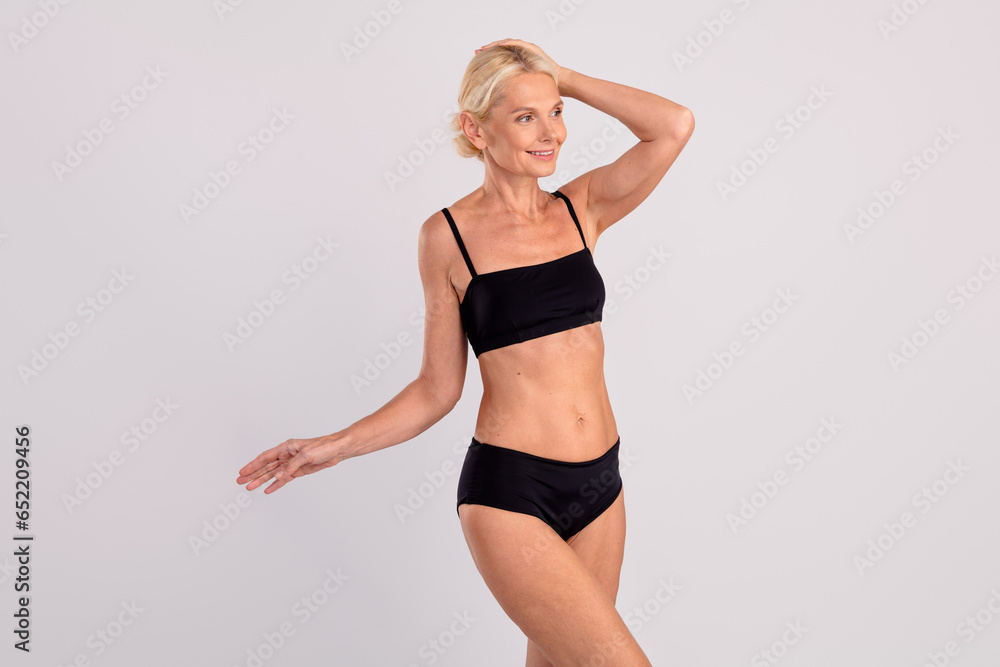 Photo of blonde woman touch her perfect head skin modeling shopping advertisement decollete black cotton isolated on gray color background Photo of blonde woman touch her perfect head skin modeling shopping advertisement decollete black cotton isolated on gray color background