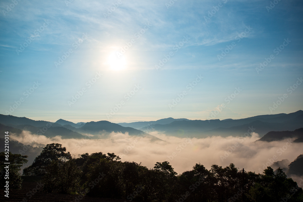 The orange-red glow of the sunrise illuminated the raging sea of clouds. Early morning view of tea gardens, sea of clouds and sunrise, Nanshan Temple. The orange-red glow of the sunrise illuminated the raging sea of clouds. Early morning view of tea gardens, sea of clouds and sunrise, Nanshan Temple.